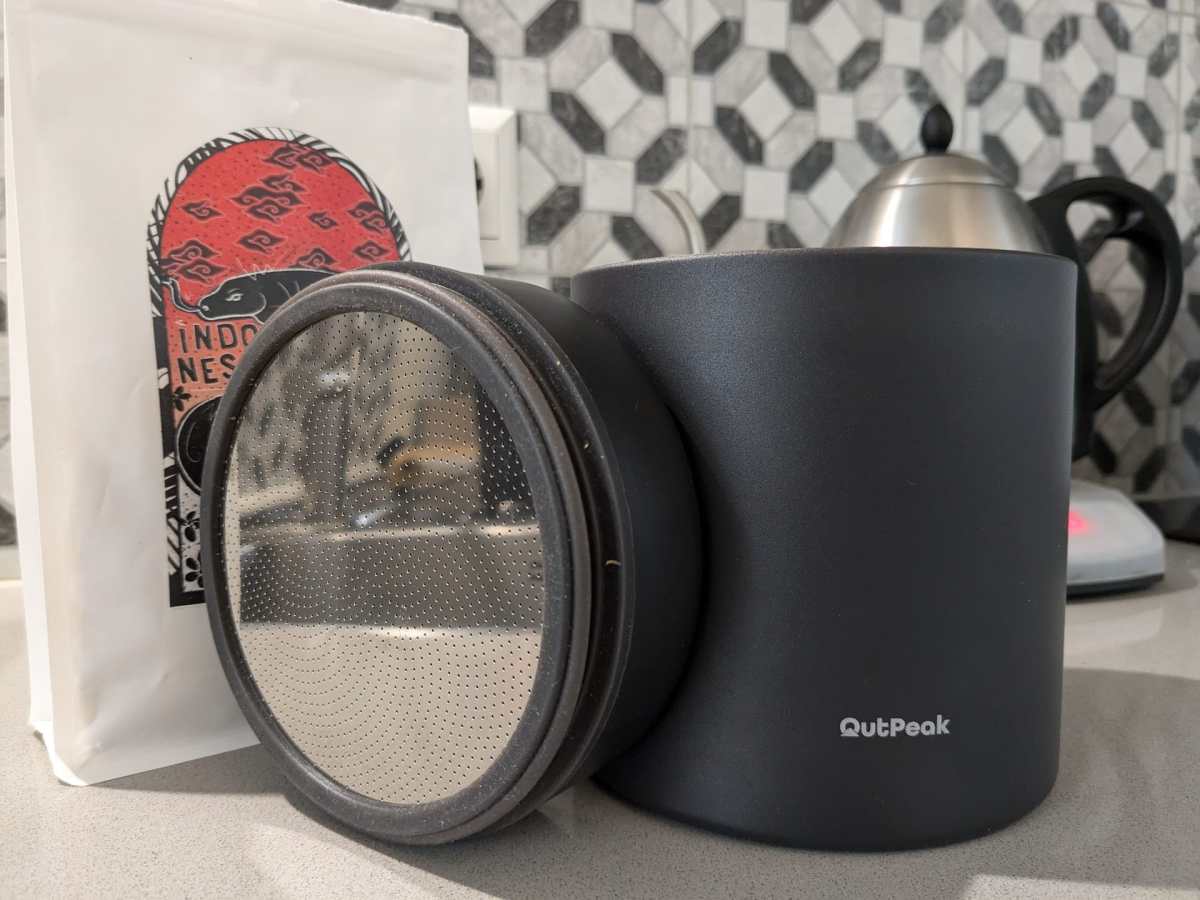 outpeak coffee canister with a bag of beans and water kettle in background